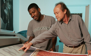 Professor Gary Keown with student Michael Kyles viewing a print on the large-format printer